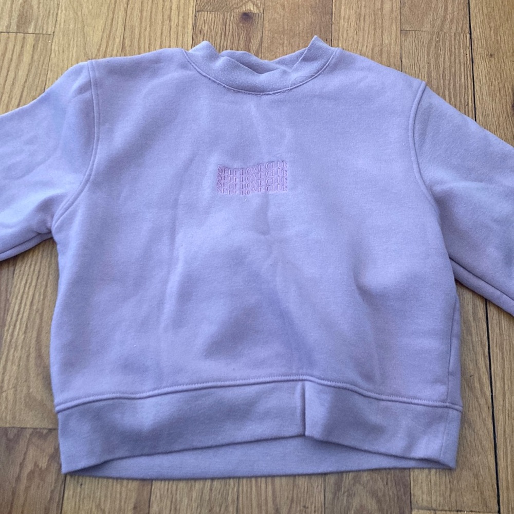 Pink, long sleeve sweater, that's 100% polyster